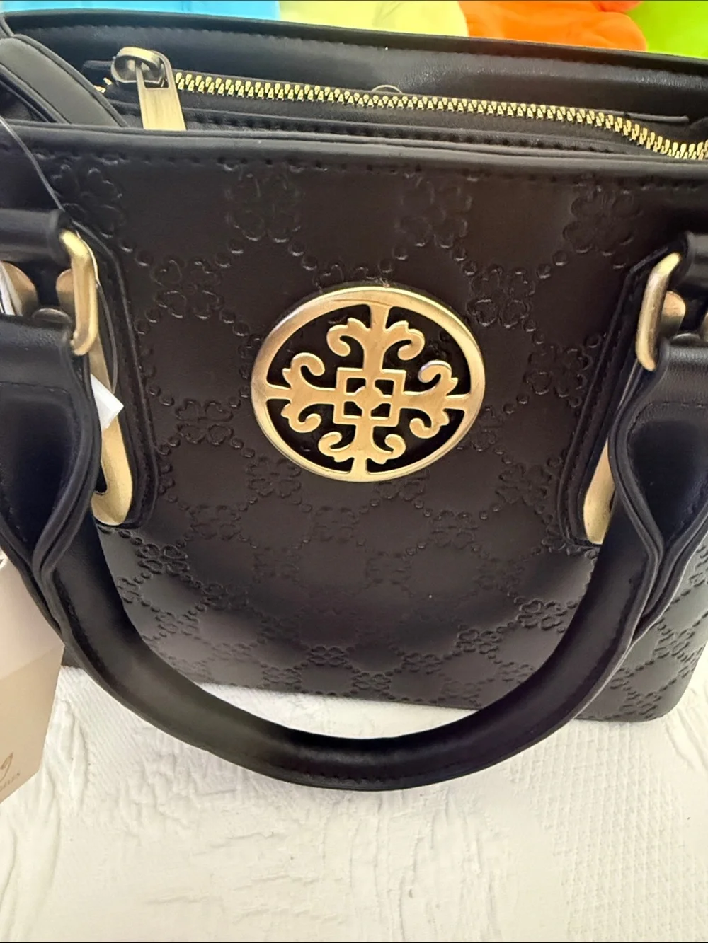 Elegant Black Quilted Satchel with Gold Emblem